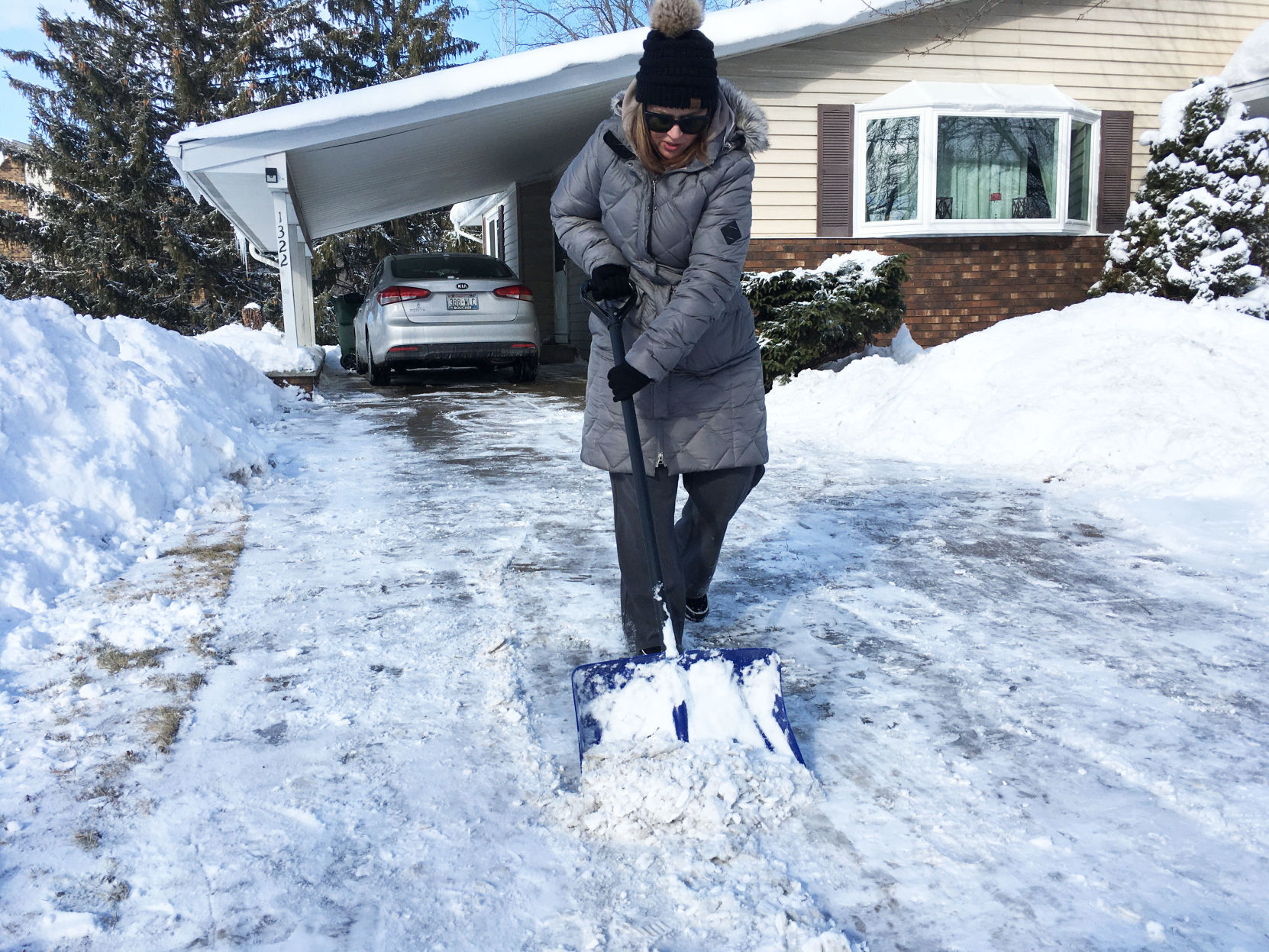 Abbie Ramon shovels show in driveway in Union Grove